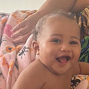 Devonte is registered to the contest to win money with this photo: baby, smiling, blanket, hand, colorful, happy, child, infant, portrait, skin, indoors, cozy, cute, person, young, expression, warm, comfort, face, closeup