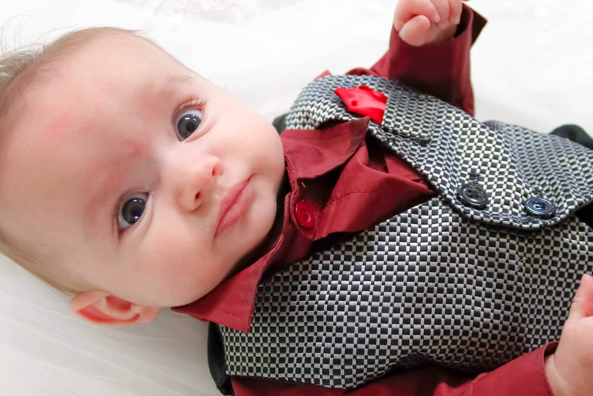 Tyler is registered to the contest to win money with this photo: baby, baby_toddler_clothing, cheek, child, collar, comfort, finger, hand, happy, lip, nail, pattern, person, pink, product, red, skin, sleeve, textile, toddler