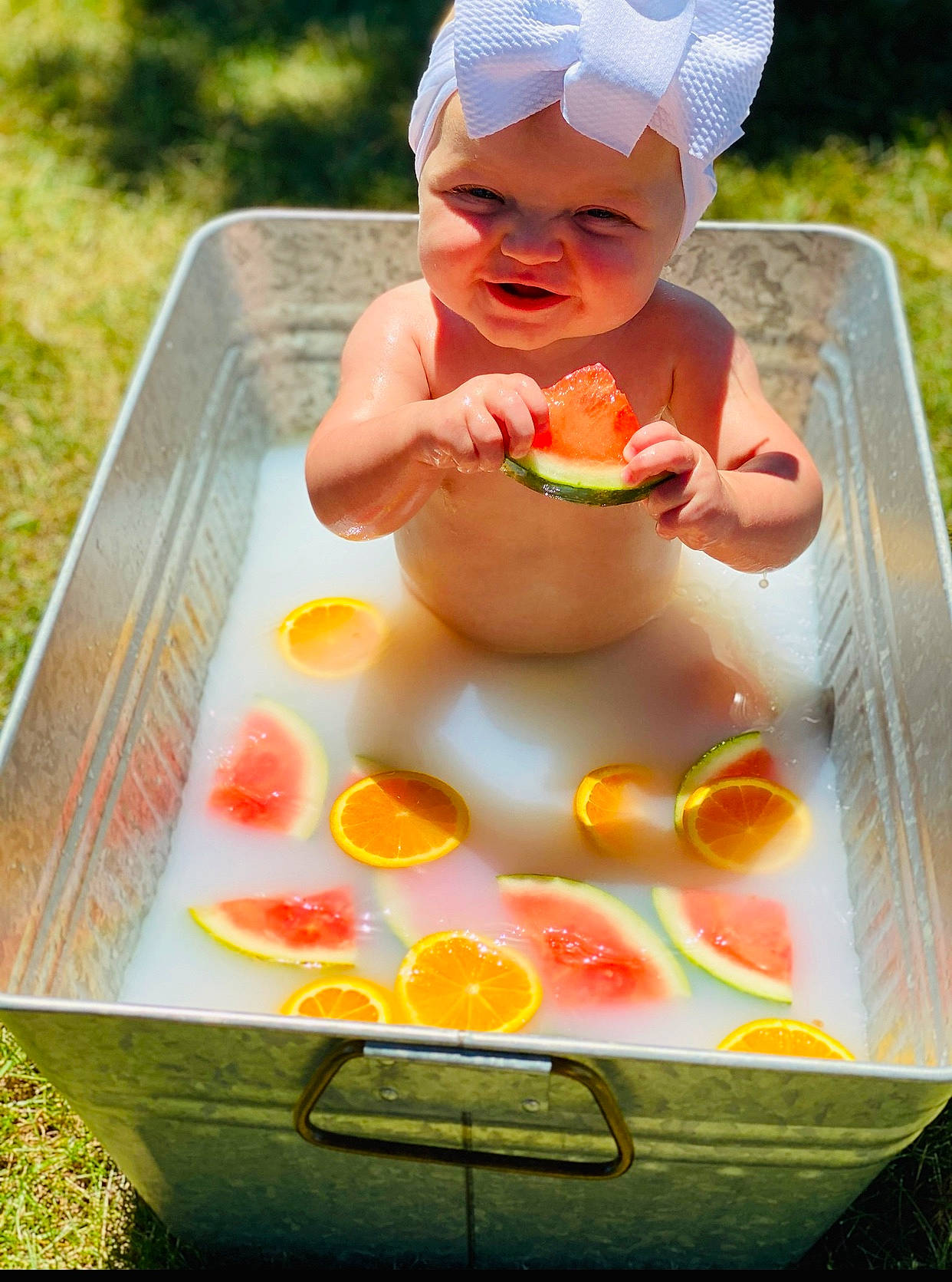 Elsie is registered to the contest to win money with this photo: baby, child, comfort_food, dish, food, fruit, headwear, orange, person, play, recreation, toddler