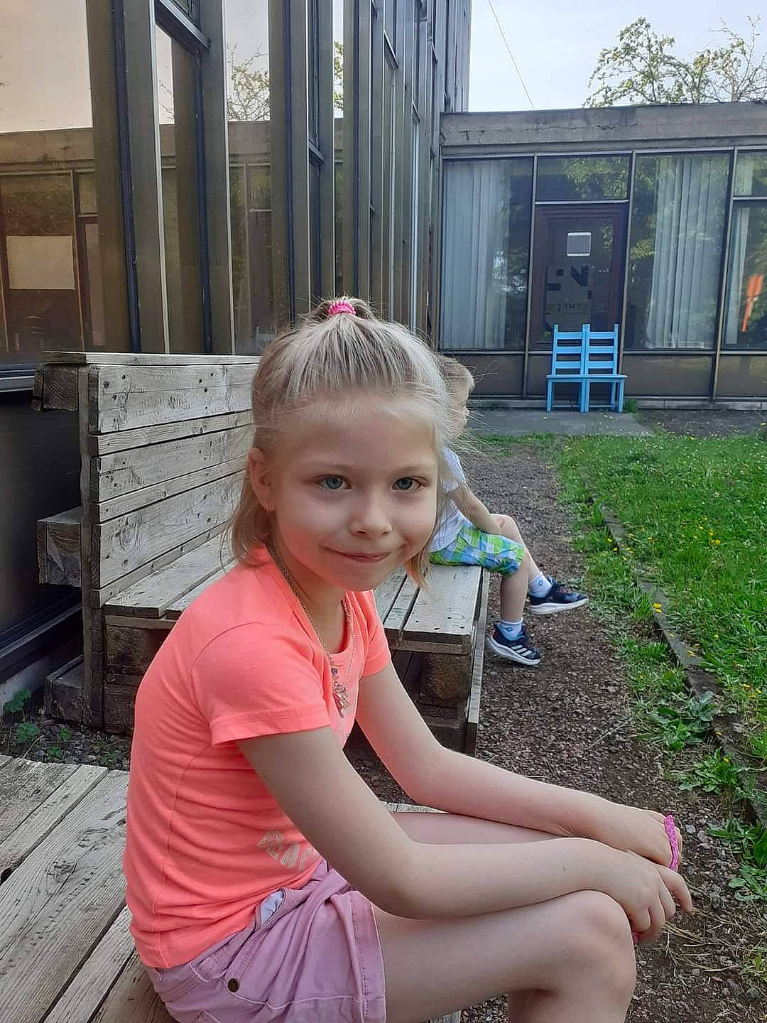 Lènna participe au concours pour gagner de l'argent avec cette photo : blond, brown_hair, child, facial_expression, fun, grass, happy, human_leg, joy, knee, leisure, person, plant, public_space, recreation, sitting, sky, smile, summer, t_shirt