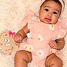 baby, infant, child, portrait, smiling, sitting, peach_outfit, floral_clothing, headband, bow, blanket, fluffy_blanket, milestone_photo, two_months, nursery, flowers, pastel_colors, indoor, happy, close_up