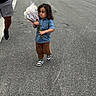 Ishamel Orta is registered to the contest to win money with this photo: adult, blue_shirt, bouquet, boy, brown_pants, car, child, curly_hair, daylight, flowers, outdoor, portrait, residential_area, road, sidewalk, sneakers, standing, street, toddler, walking