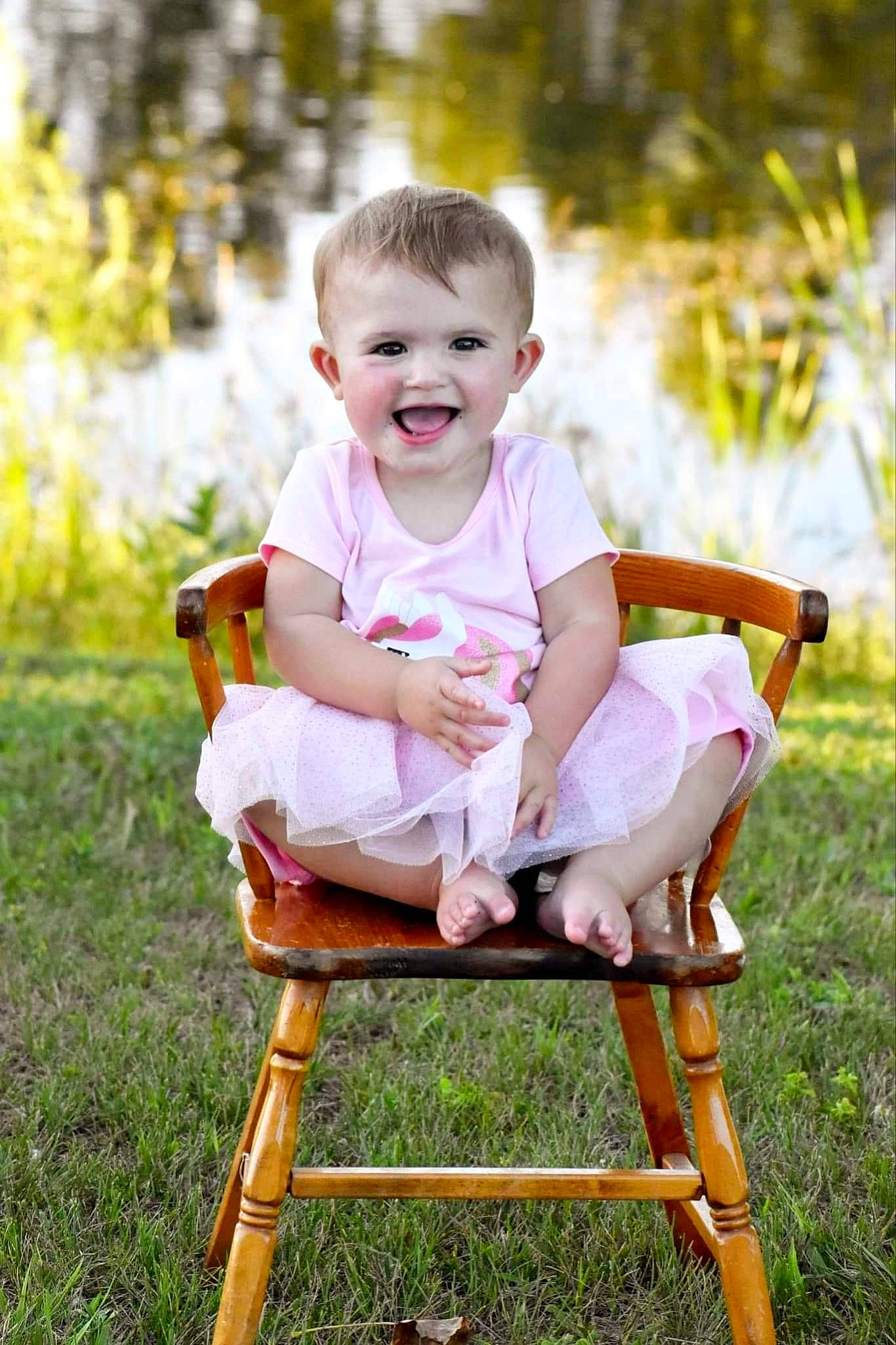 Iris is registered to the contest to win money with this photo: baby, baby_toddler_clothing, chair, child, face, finger, flash_photography, folding_chair, fun, grass, hand, happy, joy, leisure, people_in_nature, person, photograph, playing_with_kids, shorts, skin