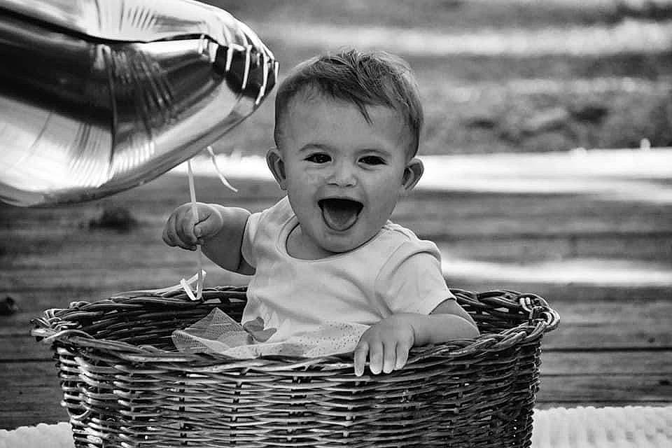 Iris is registered to the contest to win money with this photo: baby, basket, black, black_and_white, eye, face, flash_photography, fun, happy, human, monochrome, monochrome_photography, people_in_nature, person, photograph, smile, storage_basket, style, toddler, white