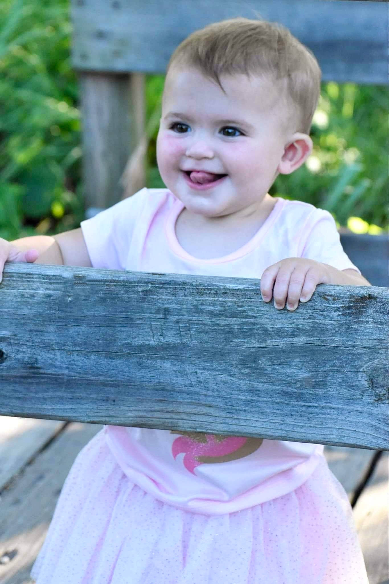 Iris joined the competition — help win amazing prizes! baby_toddler_clothing, denim, dress, face, facial_expression, grass, hair, hairstyle, happy, joy, leaf, person, pink, plant, product, skin, sleeve, smile, standing, summer