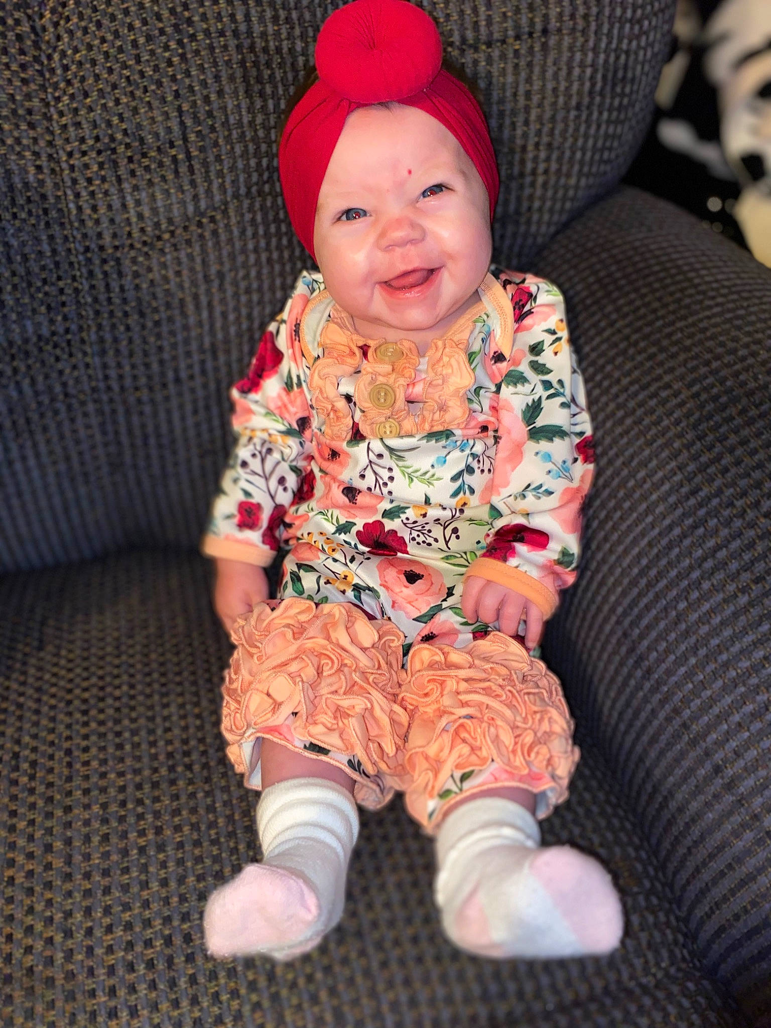 Jazlyn is registered to the contest to win money with this photo: arm, baby, baby_toddler_clothing, cap, cheek, chin, comfort, face, facial_expression, happy, headgear, headwear, human_body, lap, mouth, outerwear, person, pink, skin, sleeve