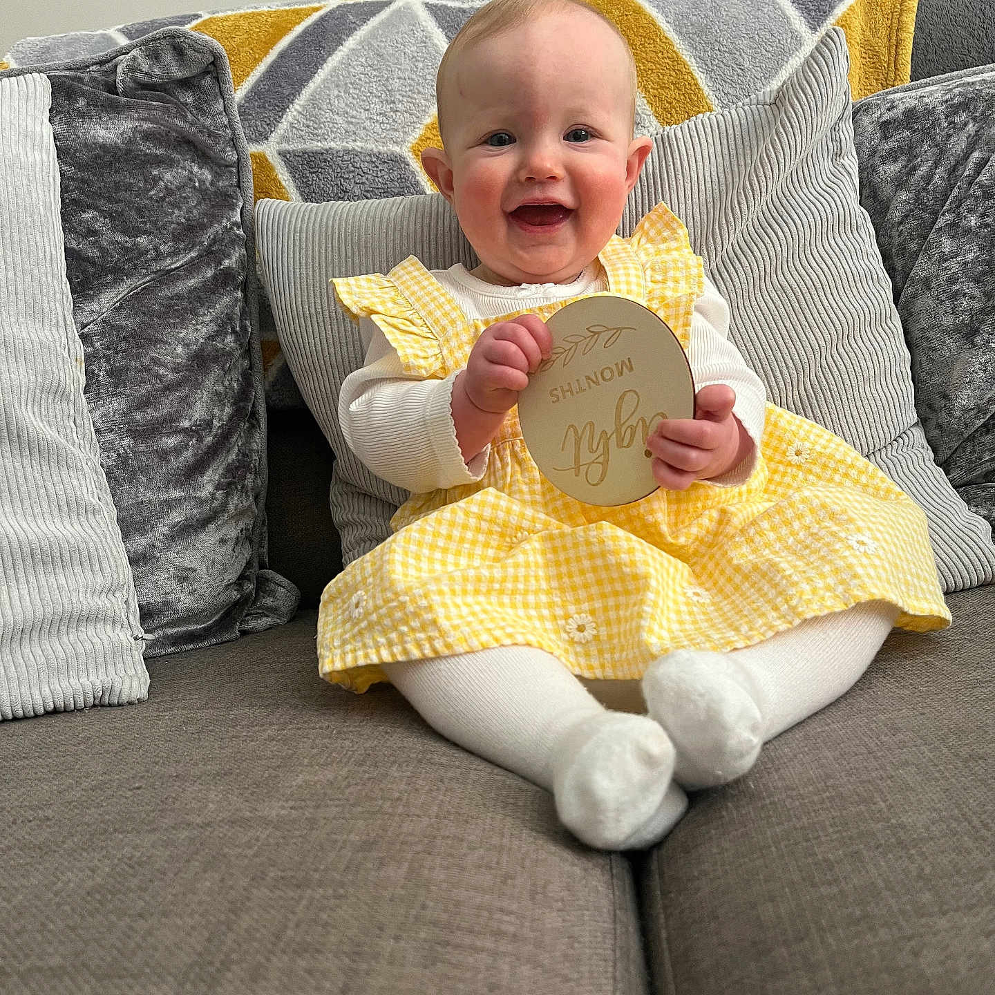 Ava joined the competition — help win amazing prizes! baby, babylaughing, blanket, clothing, couch, cushion, face, furniture, happy, head, homedecor, laughing, pants, person, photography, pillow, portrait, quilt, reading, sitting