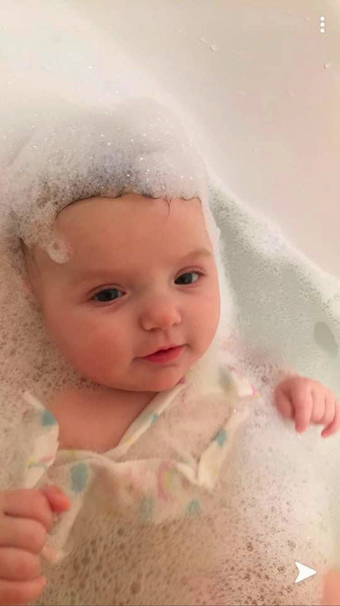 Raya is registered to the contest to win money with this photo: baby, baby_toddler_clothing, bathtub, cheek, close_up, dress, eye, eyebrow, eyelash, finger, hand, happy, headgear, headwear, iris, lip, nose, person, pink, skin