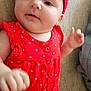 baby, infant, red_dress, headband, polka_dots, couch, indoor, cute, child, smiling, happy, person, skin, face, hand, diaper, closeup, portrait, young, fashion