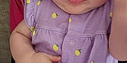 Aniyah joined the competition — help win amazing prizes! baby, child, closeup, clothing, cute, expression, hand, headband, human, indoors, infant, lemon_print, person_holding, portrait, purple_dress, red_shirt, serious_face, sitting, skin, young_child