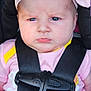 baby, infant, car_seat, headband, pink_clothing, straps, serious_expression, child, closeup, portrait, seatbelt, safety, cute, face, person, young_child, indoors, human, fashion, accessory