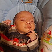 Matheo participe au concours pour gagner de l'argent avec cette photo : baby, sleeping, infant, child, clothing, sweater, striped, hand, face, cushion, baby_seat, pattern, house, colorful, resting, peaceful, portrait, indoor, cute, cozy