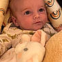 baby, infant, face, eyes, pajamas, plush_toy, bunny, blanket, soft_toy, cute, child, newborn, portrait, indoors, cozy, comfort, sleepwear, lying_down, expression, warm