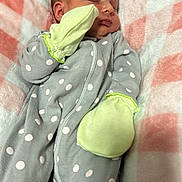Elena is registered to the contest to win money with this photo: baby, newborn, sleeping, blanket, polka_dot, onesie, mittens, infant, cozy, soft, pink, gray, white, cute, child, peaceful, portrait, resting, indoors, person