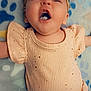 baby, infant, child, smiling, laughing, headband, clothing, peach, sparkle, blanket, paw_print, lying_down, cute, happy, face, mouth_open, skin, expression, small_person, adorable