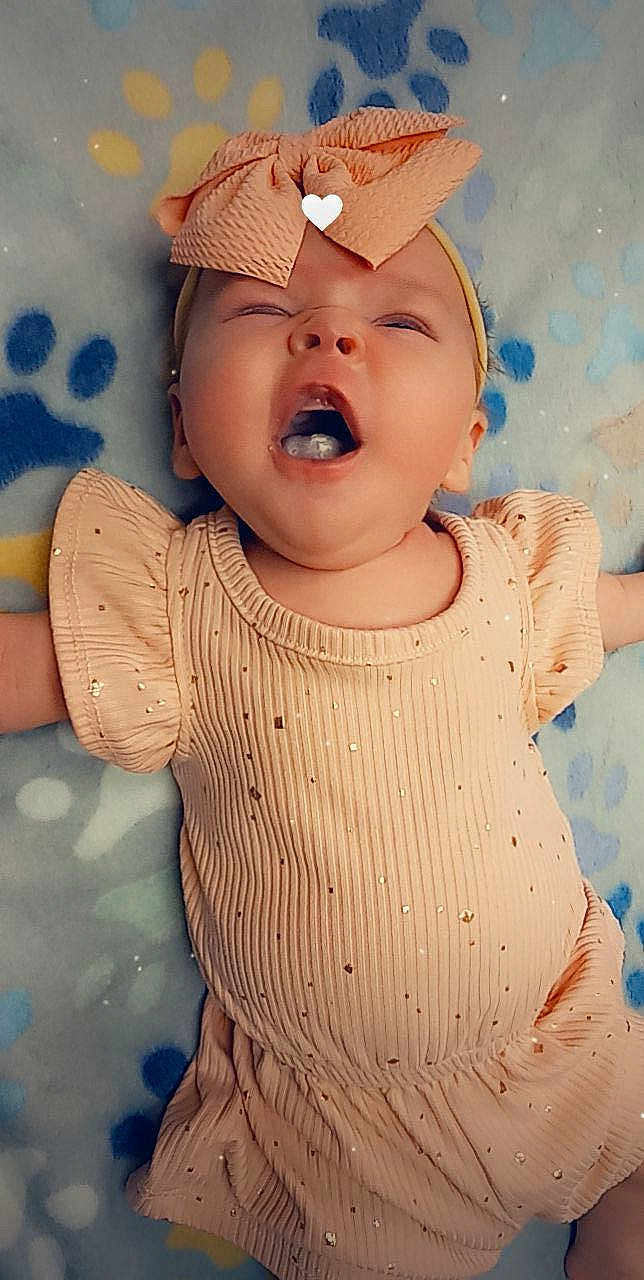 Kaleya joined the competition — help win amazing prizes! baby, infant, child, smiling, laughing, headband, clothing, peach, sparkle, blanket, paw_print, lying_down, cute, happy, face, mouth_open, skin, expression, small_person, adorable