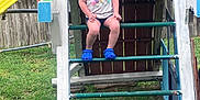 Kaleya joined the competition — help win amazing prizes! backyard, blue_clogs, bubbles, casual_clothing, child, daylight, fence, fun, grass, happy, ladder, outdoor, person, playground, playset, slide, smiling, summer, unicorn_shirt, wood