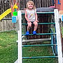backyard, blue_clogs, bubbles, casual_clothing, child, daylight, fence, fun, grass, happy, ladder, outdoor, person, playground, playset, slide, smiling, summer, unicorn_shirt, wood