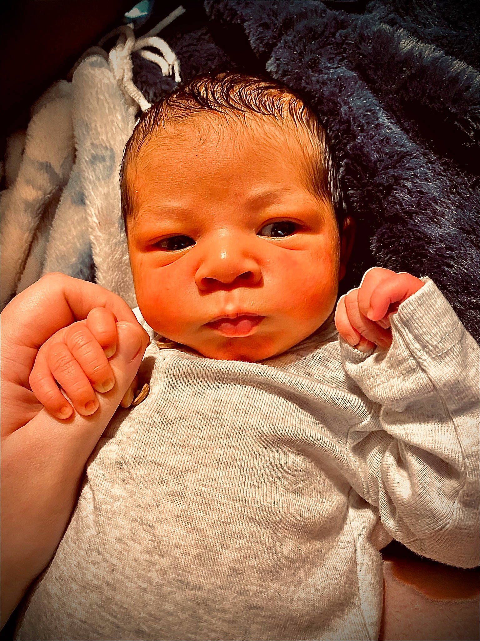 Sebastian is registered to the contest to win money with this photo: arm, baby, cheek, chin, ear, eyelash, facial_expression, finger, gesture, hand, head, human_body, lip, mouth, muscle, neck, nose, person, product, skin