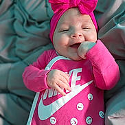 Mireyah joined the competition — help win amazing prizes! baby, pink, bow, smile, happy, infant, blanket, clothing, cute, face, headwear, person, portrait, child, apparel, soft, indoors, newborn, resting, cozy