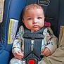 baby, infant, car_seat, blue_eyes, onesie, straps, pacifier, blanket, child, seatbelt, indoor, cute, face, hands, clothing, person, sitting, car_safety, young_child, portrait