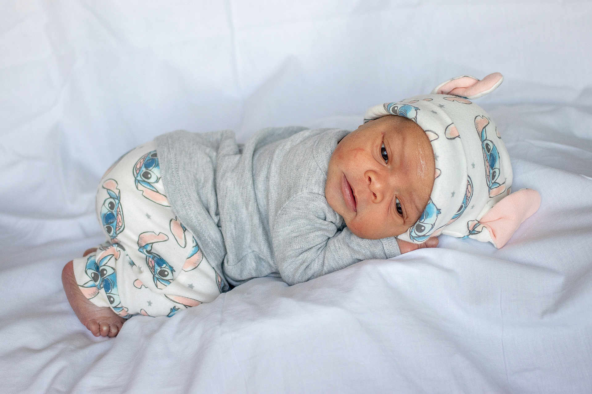 Amouri joined the competition — help win amazing prizes! baby, bed, blanket, bodypart, bonnet, cap, clothing, couch, face, finger, furniture, hand, happy, hat, head, newborn, person, photography, portrait, smile