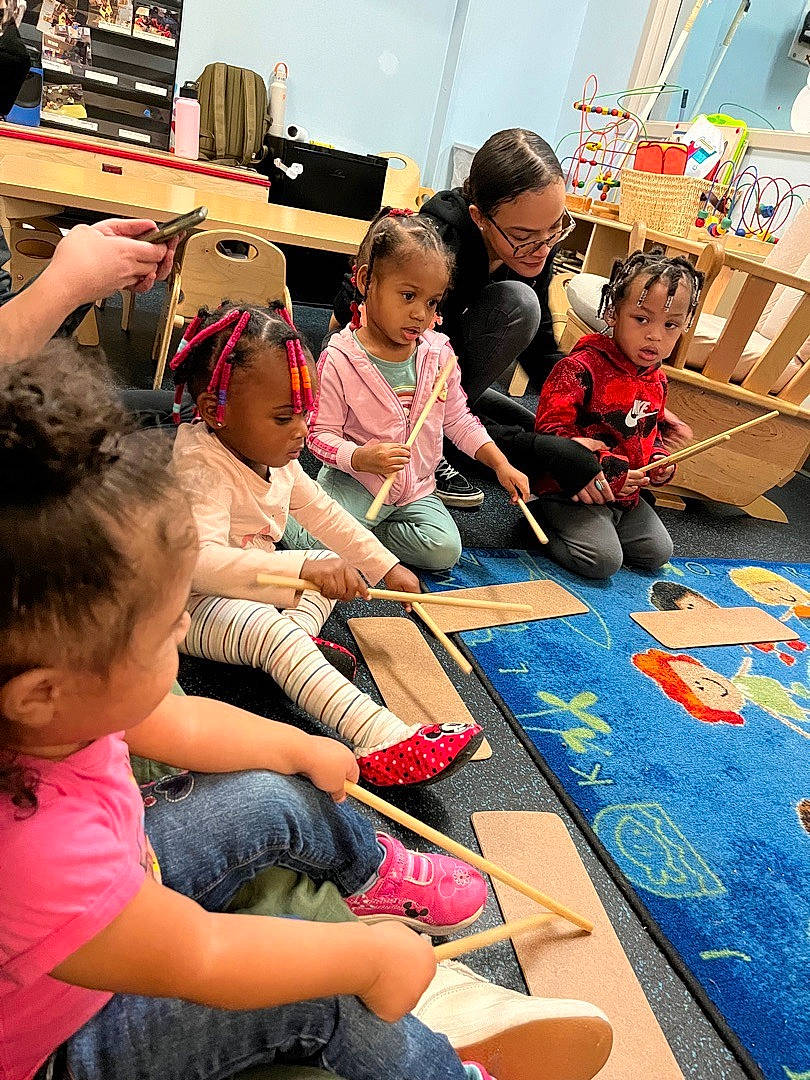 Christa is registered to the contest to win money with this photo: art, child, class, education, engineering, event, flooring, fun, kindergarten, leisure, person, play, recreation, room, sharing, shoe, sneakers, summer, t_shirt, toddler