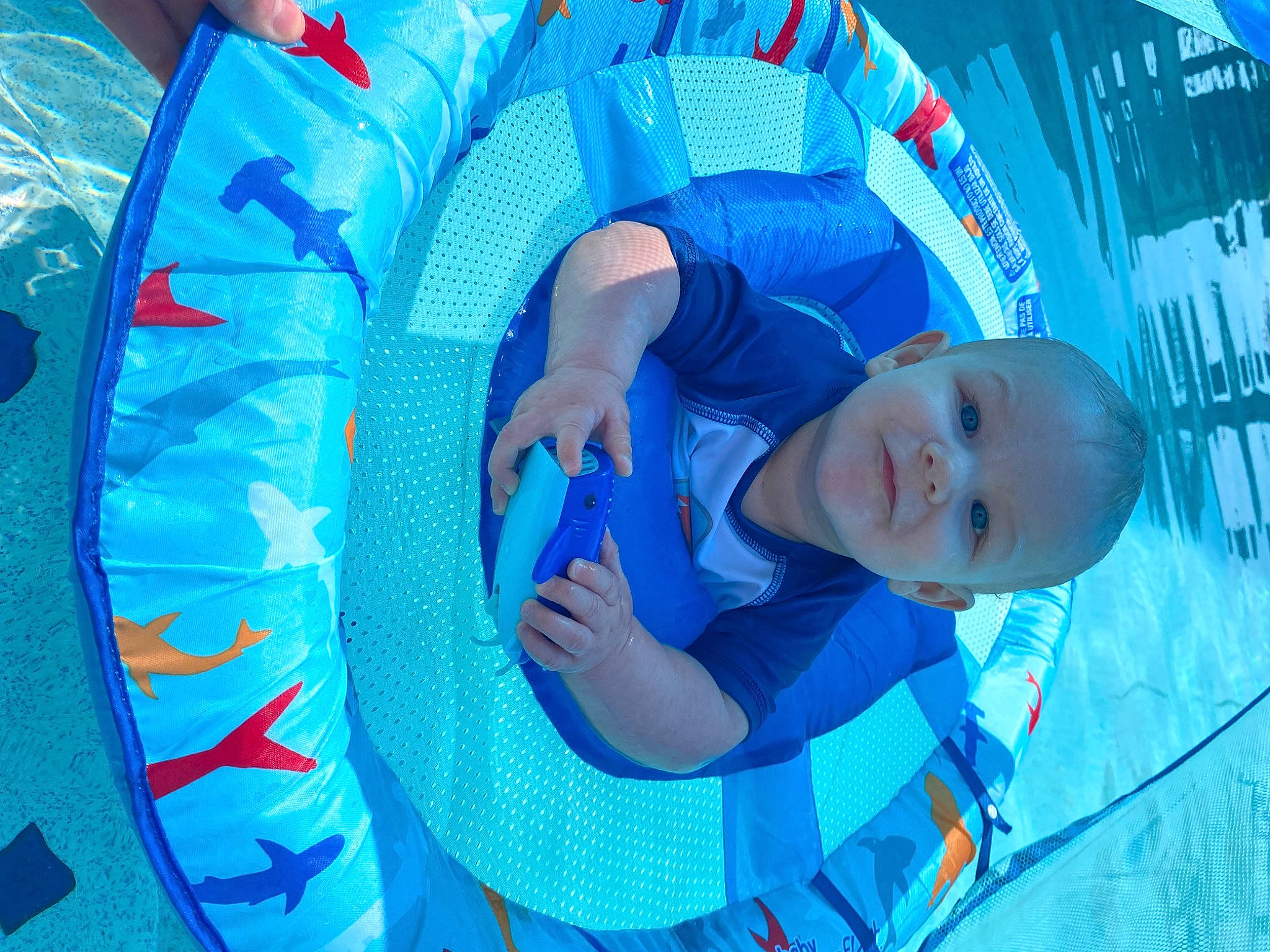 Cayson is registered to the contest to win money with this photo: aqua, automotive_wheel_system, azure, baby, blue, child, circle, comfort, electric_blue, fun, happy, leisure, pattern, person, play, recreation, smile, toddler, water, wheel