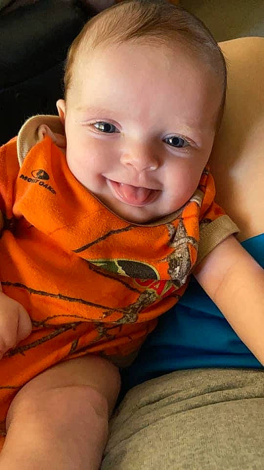 Ivey is registered to the contest to win money with this photo: arm, cheek, chin, clothing, comfort, eye, finger, hairstyle, happy, iris, lip, mouth, neck, nose, orange, person, shoulder, skin, sleeve, smile