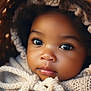 adorable, baby, basket, blanket, child, closeup, cozy, curly_hair, cute, cute_face, expression, face, hood, indoors, infant, knitted, portrait, soft_lighting, warm_colors, young