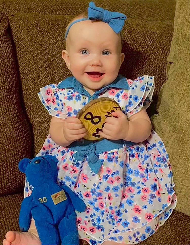 Olive is registered to the contest to win money with this photo: azure, baby, baby_toddler_clothing, blue, cheek, child, doll, dress, eye, face, happy, head, joy, person, pink, skin, sleeve, smile, t_shirt, textile