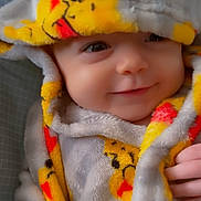 Symphanie joined the competition — help win amazing prizes! baby, smile, face, blanket, hood, clothing, yellow, gray, cute, infant, child, soft, warm, happy, portrait, closeup, cozy, babywear, person, expression