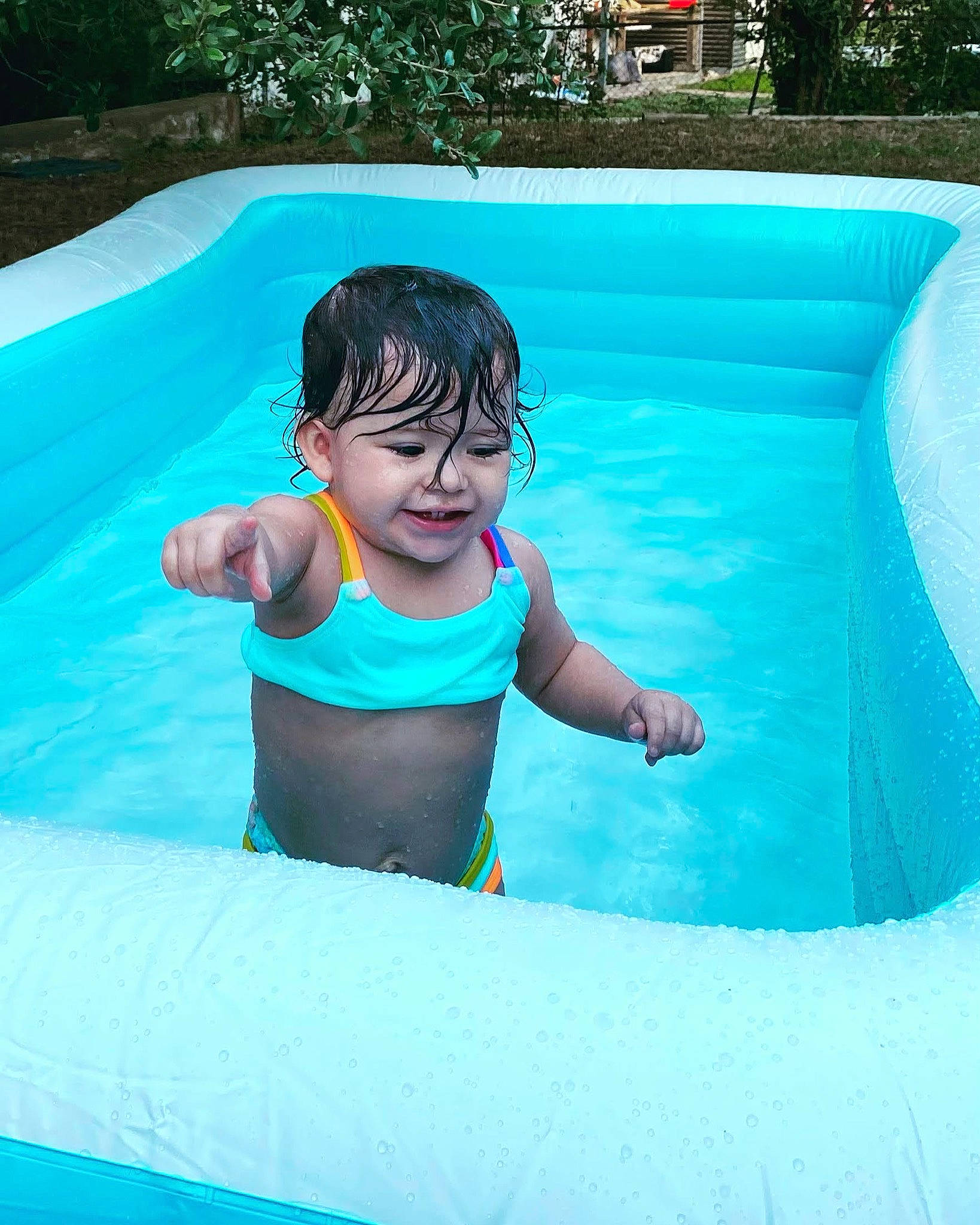 Lacy is registered to the contest to win money with this photo: aqua, azure, baby, bathing, blue, child, composite_material, electric_blue, fun, grass, inflatable, leisure, nonbuilding_structure, person, plant, play, product, recreation, smile, toddler
