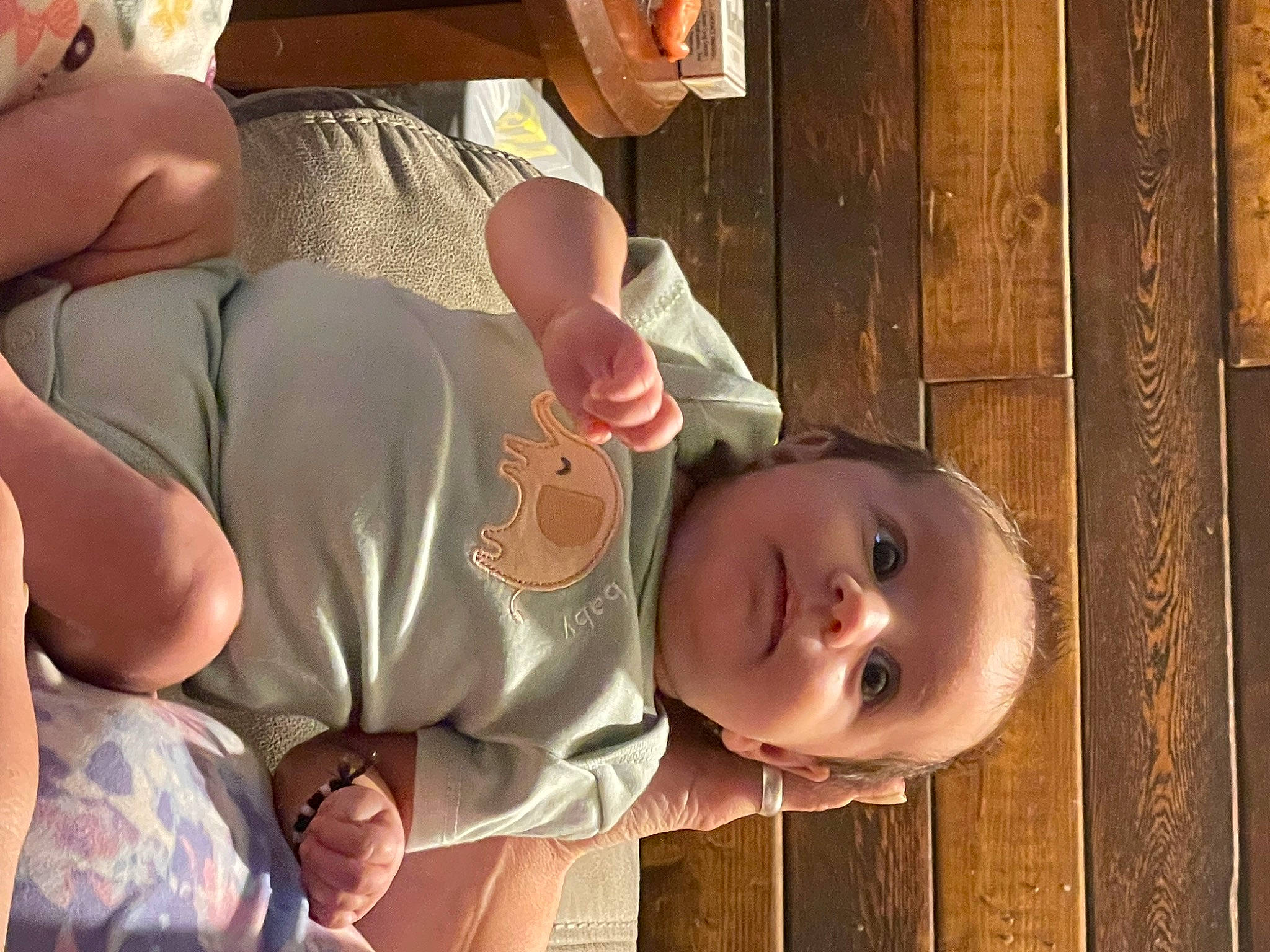 Ethel is registered to the contest to win money with this photo: arm, baby, baby_toddler_clothing, cheek, chest, child, elbow, fun, gesture, hand, happy, human_leg, mouth, nose, person, skin, thigh, thumb, toddler, window