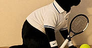 Togo a rejoint le concours — aidez-le/la à gagner de superbes lots ! cat, black_cat, tennis_racket, tennis_ball, white_polo_shirt, headband, wristbands, wooden_surface, indoor, pet, sport, animal, costume, playful, feline, side_view, accessories, table, shadow, posing