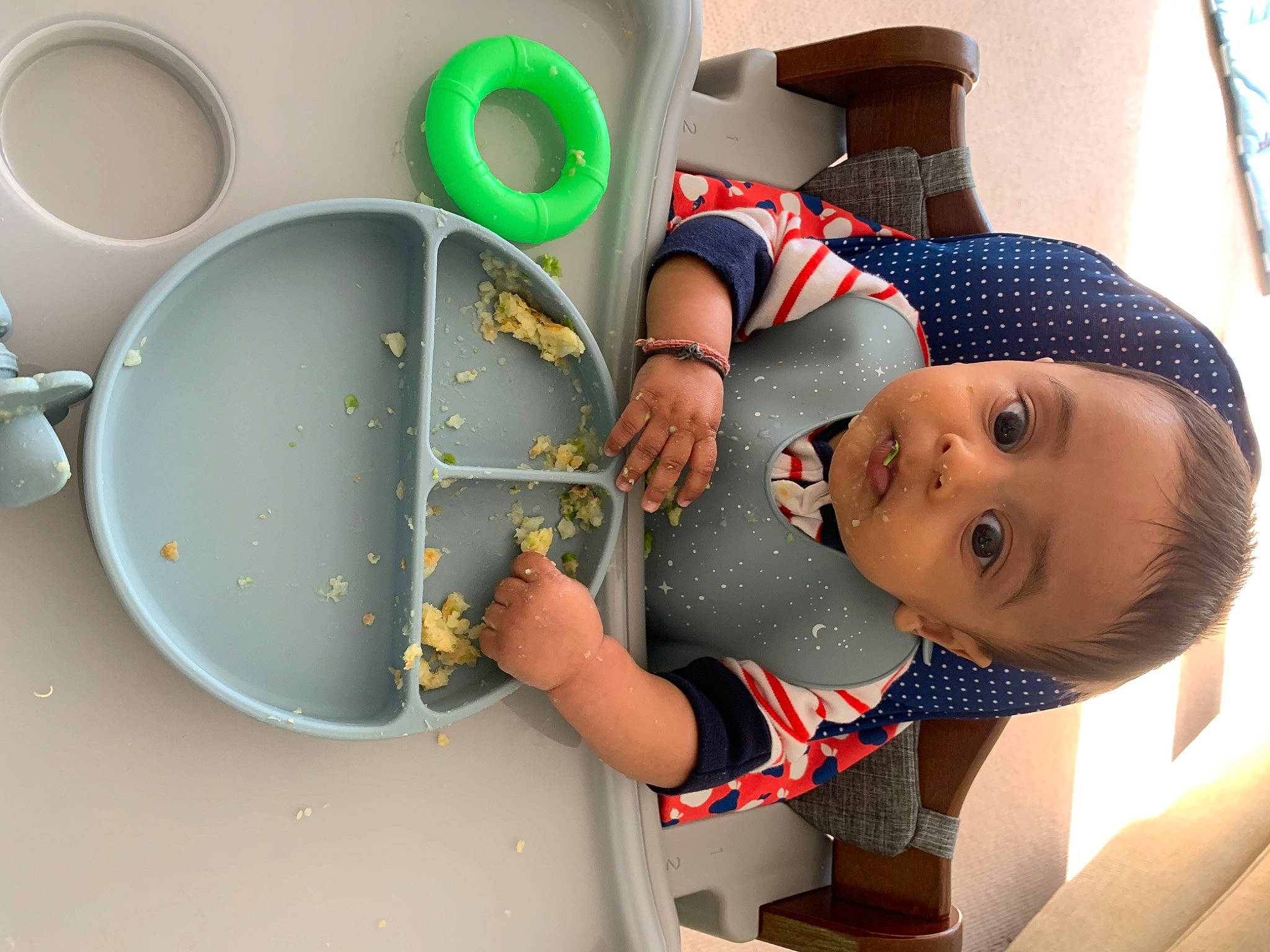 Kian is registered to the contest to win money with this photo: arm, baby, baby_products, baby_toddler_clothing, chair, child, dishware, fun, green, hat, paint, person, plate, platter, play, room, serveware, surprise, t_shirt, tableware