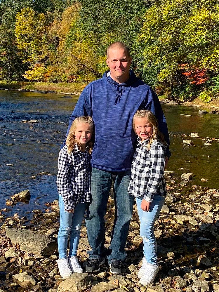 Taylin is registered to the contest to win money with this photo: body_of_water, footwear, fun, gesture, grass, happy, jeans, joy, leaf, leisure, natural_landscape, nature, people_in_nature, person, shoe, smile, standing, tree, trousers, water