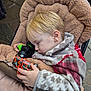 blanket, blond_hair, casual, child, comfort, cozy, cute, face, fleece, hand, outdoor, peaceful, plush, resting, sleeping, stroller, toddler, toy_trucks, warm_clothing, young_child