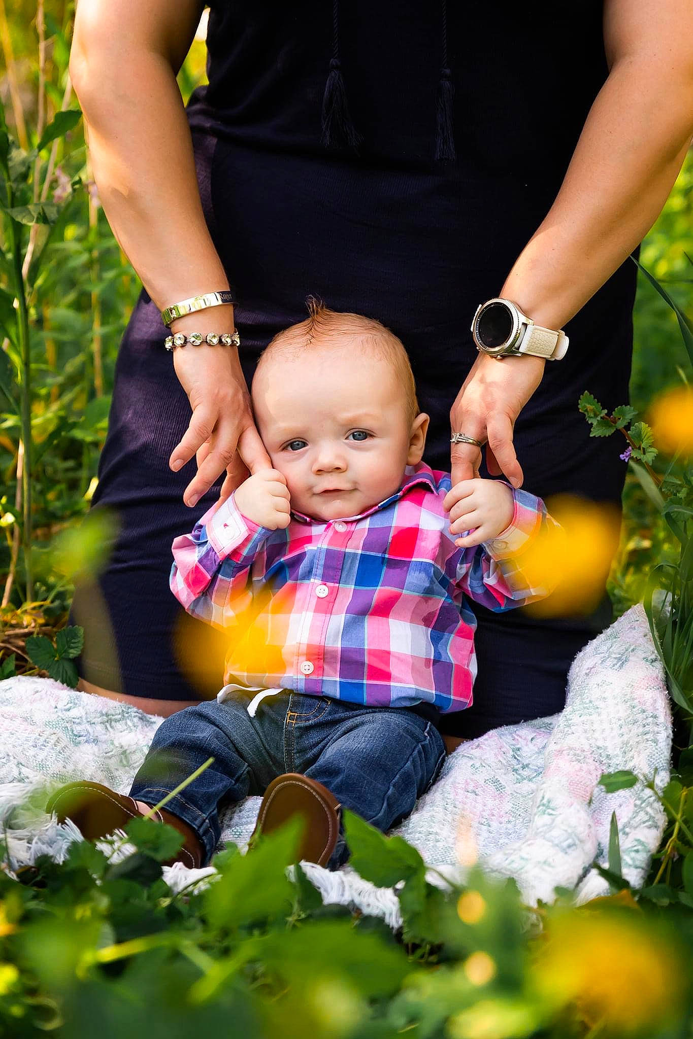 Ruger is registered to the contest to win money with this photo: baby, baby_toddler_clothing, child, clothing, dress, finger, fun, gesture, grass, hand, happy, leisure, orange, people_in_nature, person, plant, sitting, summer, toddler, watch