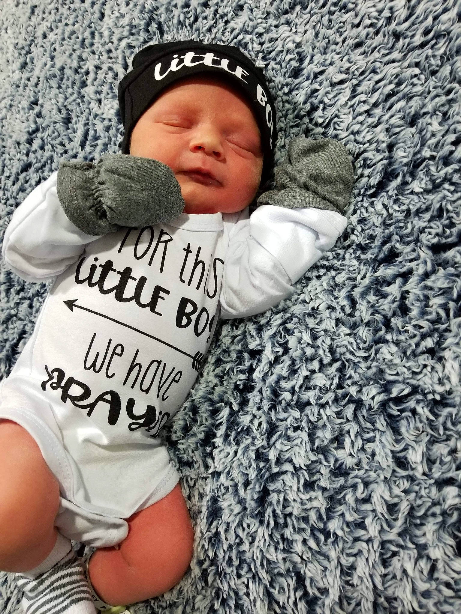 Ruger is registered to the contest to win money with this photo: baby, baby_toddler_clothing, cap, cool, finger, grass, grey, hand, happy, headgear, headwear, organ, outerwear, people_in_nature, person, photograph, shorts, sleeve, t_shirt, textile