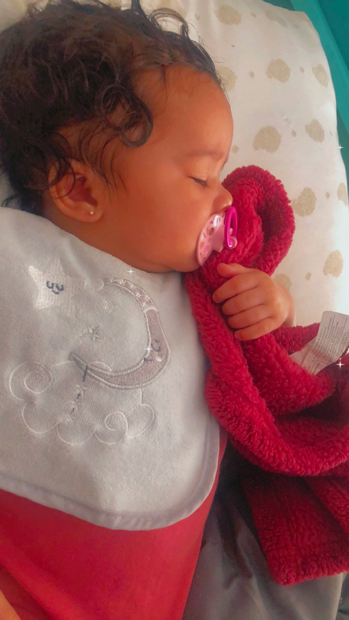 Jenesis is registered to the contest to win money with this photo: baby, baby_toddler_clothing, cheek, comfort, ear, eyelash, happy, head, lip, mouth, nail, neck, nose, organ, person, pink, red, skin, sleeve, textile