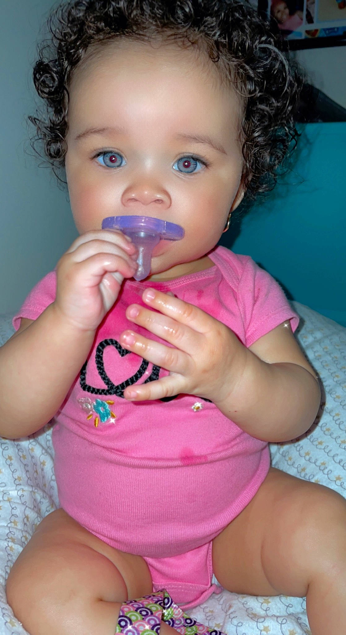 Jenesis is registered to the contest to win money with this photo: arm, baby_toddler_clothing, cheek, drinkware, eye, eyelash, gesture, hair, happy, head, iris, joint, lip, mouth, muscle, nose, organ, person, pink, skin