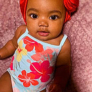 Serenity joined the competition — help win amazing prizes! baby, infant, child, face, headwrap, red, onesie, floral_pattern, pink_blanket, portrait, cute, looking, skin, eyes, young_child, sitting, indoors, soft_texture, colorful, adorable