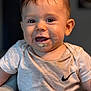 baby, child, smiling, food, messy, face, tshirt, nike_logo, sitting, indoor, cushion, happy, young, cute, portrait, infant, person, clothing, mouth, expression
