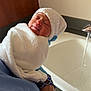 newborn, baby, towel, hat, glove, hand, sink, water, bathroom, sleeping, infant, person, wrapped, white, blue, skin, face, closeup, rest, comfort