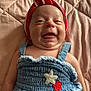 baby, smiling, hat, red, white, blue, denim, clothing, star_patch, quilted_blanket, lying_down, happy, cute, child, infant, portrait, face, skin, headwear, fabric