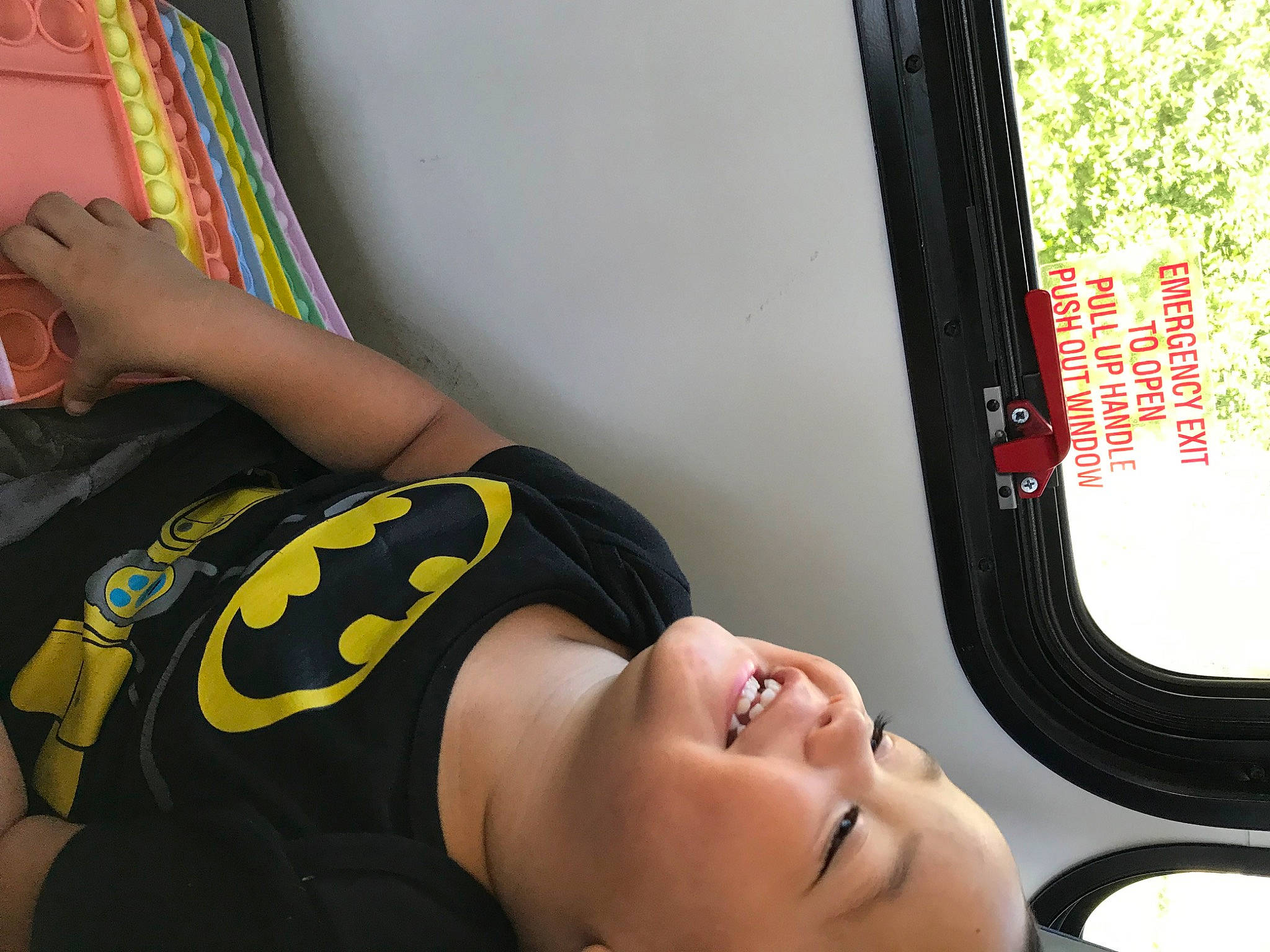 Cory James is registered to the contest to win money with this photo: automotive_design, black_hair, child, comfort, elbow, eyewear, fashion_accessory, fun, human_leg, joy, knee, leisure, mouth, person, room, sitting, smile, sportswear, thigh, vehicle_door