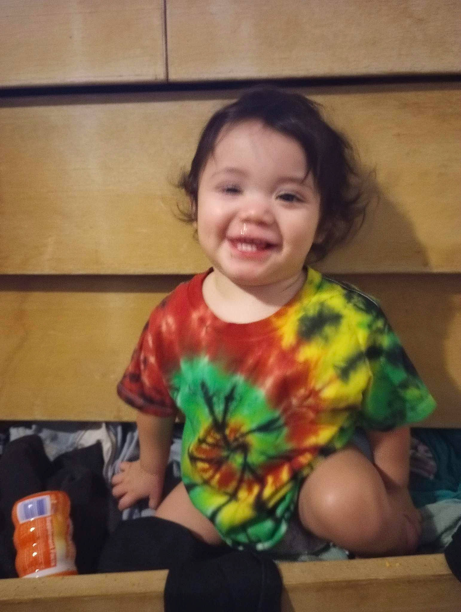 Cory James is registered to the contest to win money with this photo: arm, baby, baby_toddler_clothing, cheek, child, cloud, fun, happy, human_body, iris, joy, nose, pattern, person, play, room, sitting, sleeve, smile, t_shirt