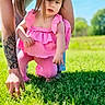 Mylie is registered to the contest to win money with this photo: adult, blue_sky, casual, child, curious, daylight, exploration, grass, greenery, kneeling, nature, outdoor, person, pink_clothing, play, summer, sunny, tattoo, toddler, young