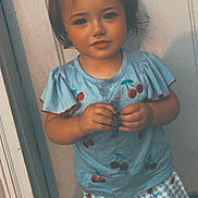 Mylie joined the competition — help win amazing prizes! toddler, child, door, clothing, top_knot, cherry_pattern, shorts, shirt, standing, outdoor, person, cute, young_child, portrait, smiling, hair, fashion, summer, warm_lighting, vintage_style